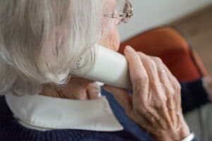 donna anziana che telefona con il telefono fisso
